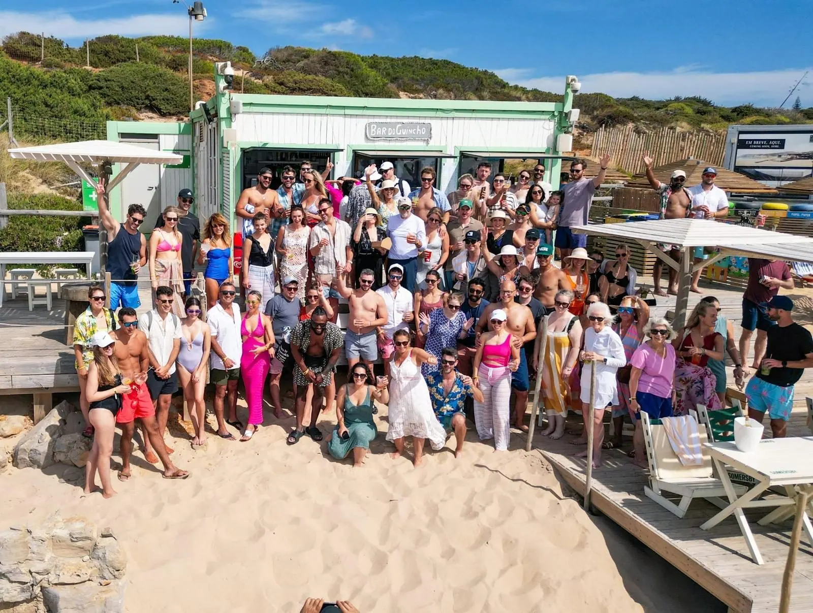 Wedding guests gathered together on the beach at Bar do Guincho in Portugal